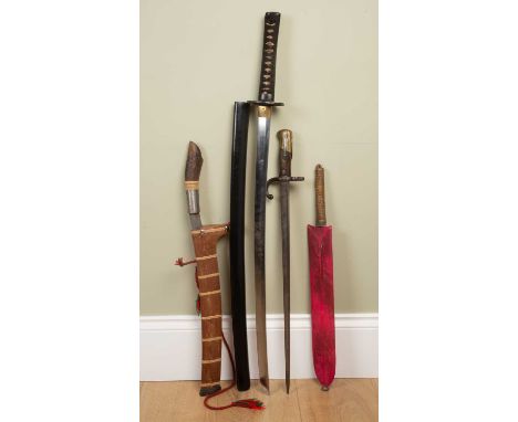 A group of swords and knives to include a kukri knife in wooden sheath, the blade 44cm long; a sword with carved ebonised hil