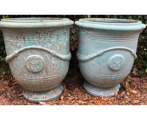 A pair of green glazed large garden planters with applied seal decoration, 67cm diameter x 75cm highQty: 2Both planters with 