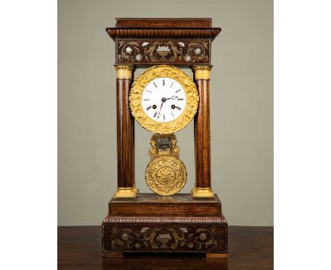 A French walnut portico clock with brass and mother of pearl decoration, the white enamel dial marked with Roman numerals wit