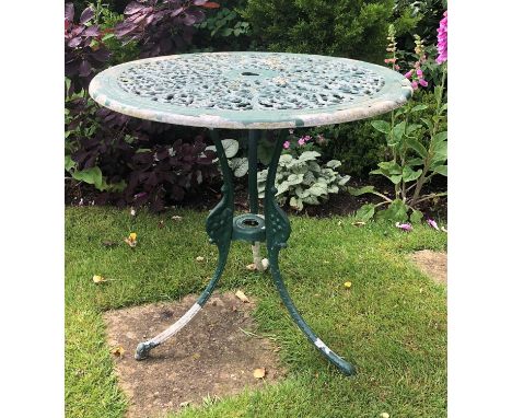 A green painted circular aluminium garden table with pierced top and tripod base, 69cm diameter, 65cm highPaint very worn, th