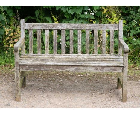 A small teak garden bench with slatted back and seat, 121.5cm wide, 55cm deep, 84cm highWeathered overall, structurally sound