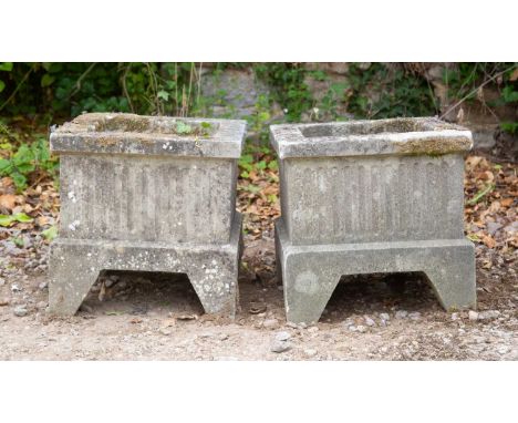 A pair of small cast reconstituted stone square planters on shaped bracket feet, each 36cm wide, 36cm highWeathered overall o