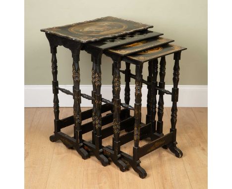 A nest of four Victorian papier mâché tables, on turned supports, three with decorative medallions to the top within gilt and