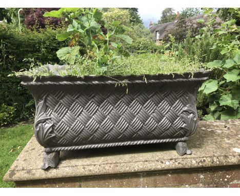 A composite planter or trough in the French style, with basket weave edges, approximately 66cm wide, 40cm deep, 32cm high; to