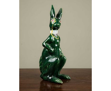 A ceramic green hare with monocle and bow tie, with glass eyes, in the manner of Brannam, 36.5cm highSome chips to the ears o