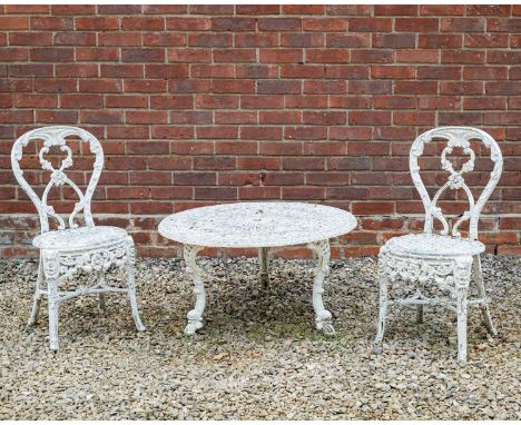 A pair of white painted cast aluminium garden chairs with shaped backs, lattice work seats and splaying legs, 40cm wide x 82c