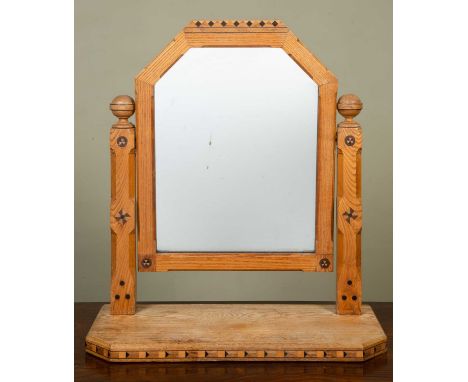 An Arts and Crafts oak dressing table mirror with inlaid medallions to the frame, 58cm wide x 24.5cm deep x 64.5cm highSome s