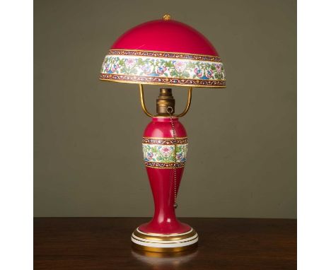 A Minton puce ground ceramic table lamp with a semi-spherical shade and body decorated with bands of flowers; the shade 26cm 