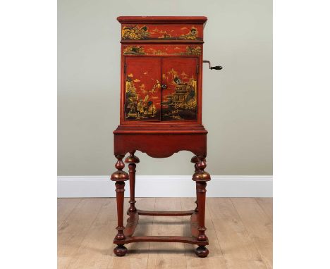 An early 20th century gramophone on stand, with red ground Japanned decoration depicting temples and foliage amongst mountain