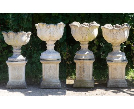 A set of three cast reconstituted stone garden urns decorated with acanthus leaves on octagonal bases; three plinths with fru