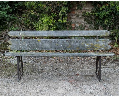 An old garden bench with cast iron ends, with wooden back and seat, 183cm long, 44cm deep, 79cm highWeathered overall.