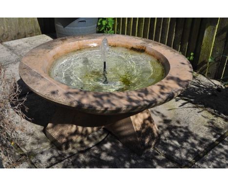 A cast reconstituted stone garden fountain, a shallow conical bowl on four bracket feet, 100cm diameter, 44cm highVery minor 