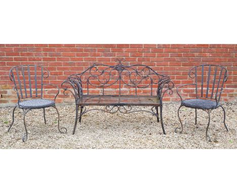 A black painted wrought iron garden seat, with scroll ornament to the back and arms, 141cm wide, 94cm high; together with a p