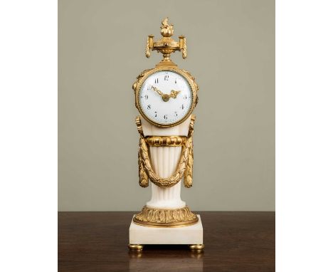 An early 20th century French ormolu and marble timepiece in the Classical style, with flaming vase finial over enamelled dial