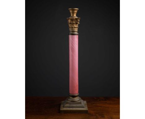 A late 19th / early 20th century spiralled pink glass and brass lamp base of column form with a stepped base, 56cm highIn goo