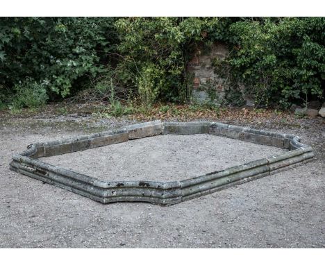 A shaped Haddonstone pond surround with inverted corners and making up a rectangle approximately 280cm long x 220cm deep x 16