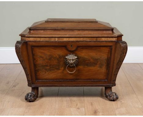A William IV mahogany cellarette, of sarcophagus form with lion mask ring handle to the front, carved brackets to the corners