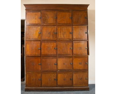 A walnut locker with twenty cupboards, each with an internal fitted shelf, brass numbers and handles, on plinth base, 167cm w