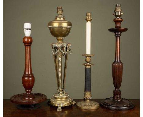 A group of four various decorative table lamps to include two turned mahogany lamps; a brass oil lamp converted for electric 