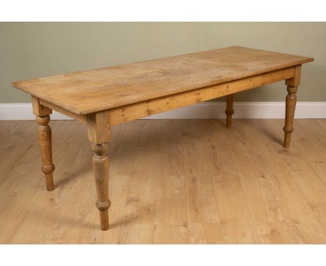 A pine kitchen table on turned legs, 215cm long x 83cm deep x 77cm highSurface dents, marks and scratches, ring marks and wat