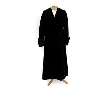 An Early 20th Century Black Evening Coat, with collar, fold back buttoned cuffs and two-button fastening to the waist