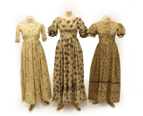 A Circa 1840's Wool Dress, printed with large pink floral sprigs, capped sleeves with three tiers of gathered trims edged wit