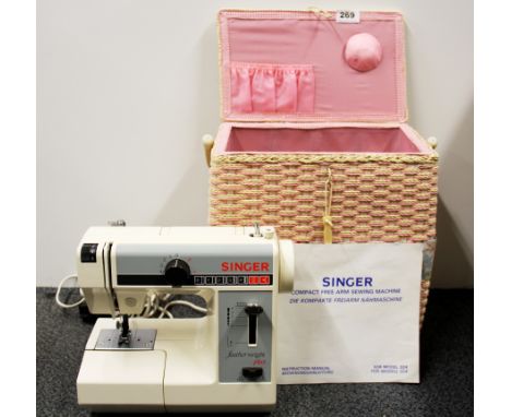 A vintage Singer featherweight sewing machine and woven carrying case.