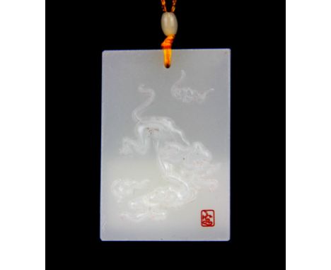 A Chinese carved white jade amulet of a tiger on white jade bead necklace.