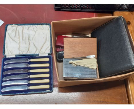 A box of mixed vintage cutlery and other items.