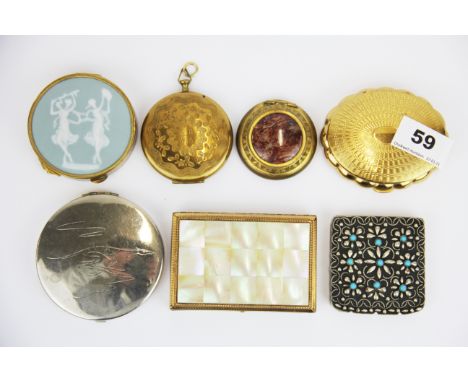 A group of seven vintage compacts.