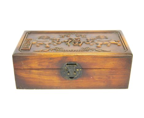 A pair of green and lavender jade bangles in a carved wooden presentation box, box W. 28cm, internal bangle Dia. 6cm.