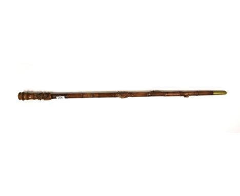 An oriental carved wooden walking stick with detachable handle, L. 97cm.