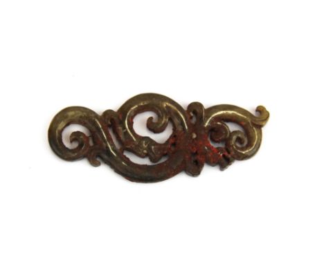 A Chinese carved archaic form jade amulet of a dragon with pigment and other residue, L. 9.5cm.