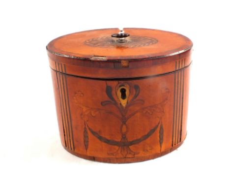A Sheraton period oval mahogany tea caddy with cross banding and stylised leaf inlays (some veneer loss)