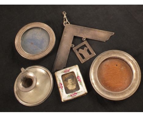 Two small silver circular frames (as found), a porcelain photo frame, a continental small chamberstick plus a silver Masonic 