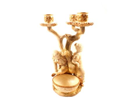 A Royal Worcester three branch figural candelabra