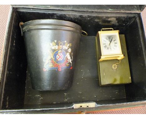 A tin trunk containing a leather fire bucket, cash tin, quartz clock plus two fishing rods