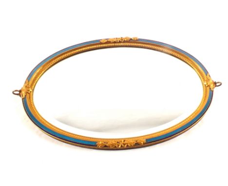 An oval French wall mirror with two colour blue enamel and gilt decoration, 9 1/2" x 14"