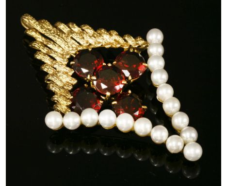 A Continental gold garnet and cultured pearl brooch/pendant, c.1970, of open lozenge form with a series of graduated bark tex
