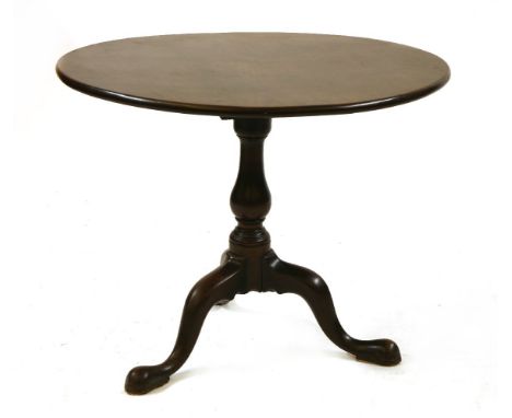 A George III mahogany tripod table, the circular top on baluster column and tripod base, 88cm x 70cm