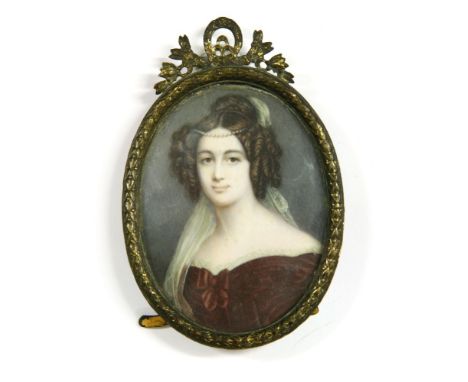 A 19th century miniature portrait, signed Poilly, on ivory, depicting head and shoulders of a young woman in a red dress, wit