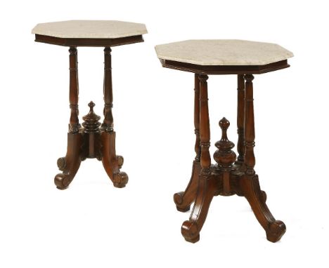 A near pair of octagonal lamp tables, late 19th century, each with a marble top over four column stands and on carved scrolli