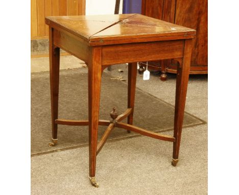 An Edwardian rosewood envelope card table, with a frieze drawer on square tapering supports and castors, 73cm high, 56cm wide