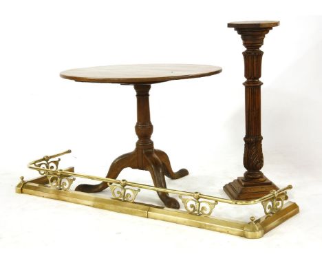A George III mahogany circular tripod table, with a turned central column, 91cm diameter, 68cm high, together with a brass fe