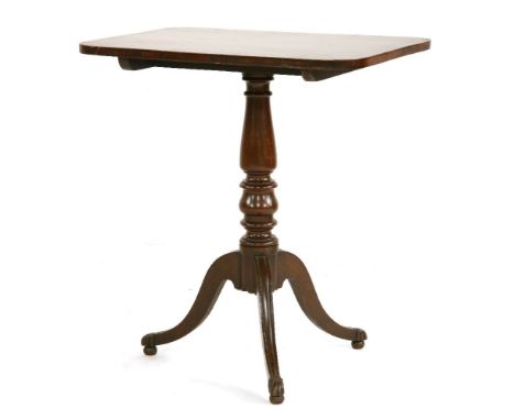 A mahogany tilt-top table, early 19th century, possibly Irish, the rectangular rosewood crossbanded top on a urned support tr