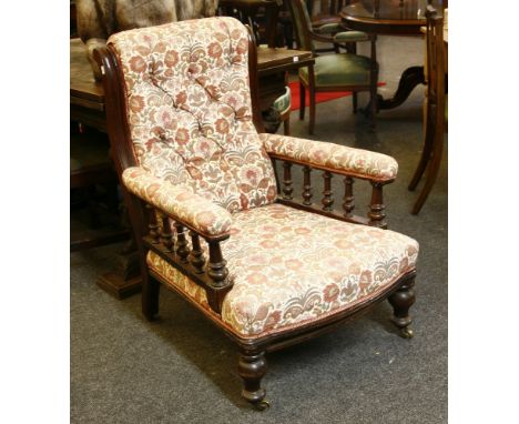 A Victorian mahogany armchair, the button back above stuff over seat, on turned feet, 94cm high