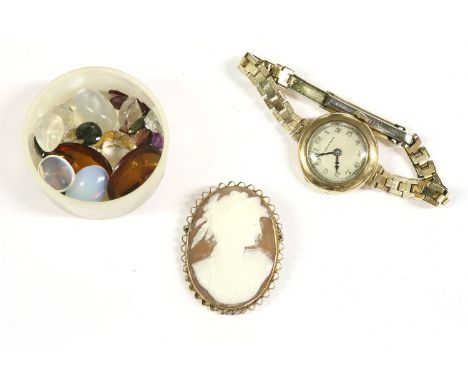 A ladies gold Walker and Hall bracelet watch, Arabic numerals on a rolled gold bracelet, 16.15g, a gold shell cameo brooch, 6