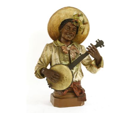 A Goldscheider-type maiolica terracotta and painted bust of a musician, late 19th century, in a wide brimmed hat, playing the