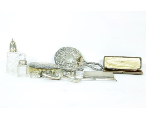A quantity of silver items, to include a cigarette case, planished brush, mirror, spoons, napkin rings, cut glass bottle and 