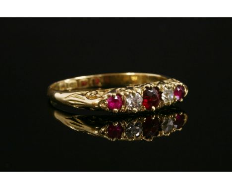 An 18ct gold, five stone, garnet-topped doublet, ruby, synthetic ruby and diamond carved head ring, a garnet-topped doublet, 